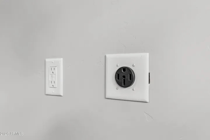Garage includes electric vehicle wall outlet.