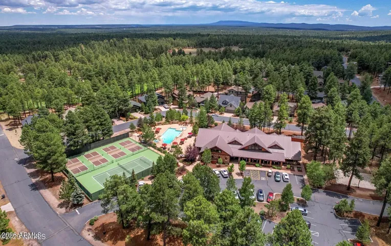 Aerial view of community center, pool, pickleball and tennis courts,