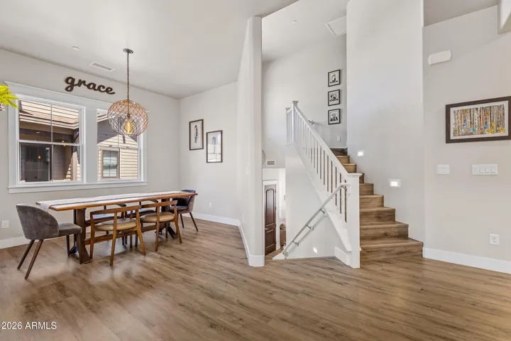 Open concept area with dramatic stairs leading to Primary Bedroom level.