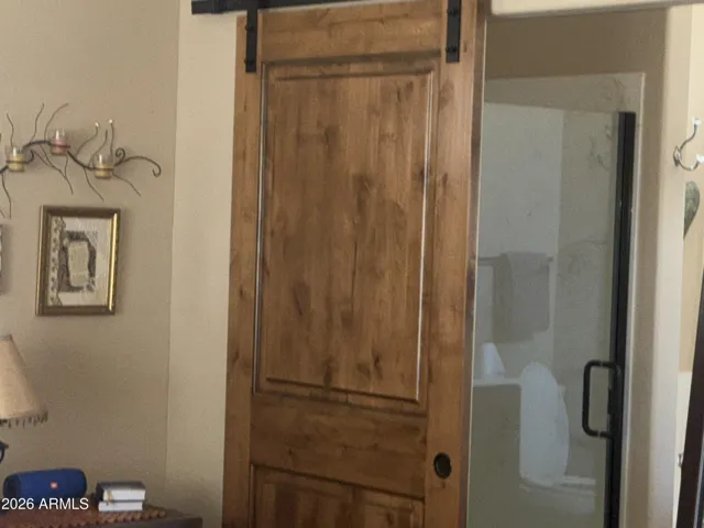 Barn door into primary bathroom