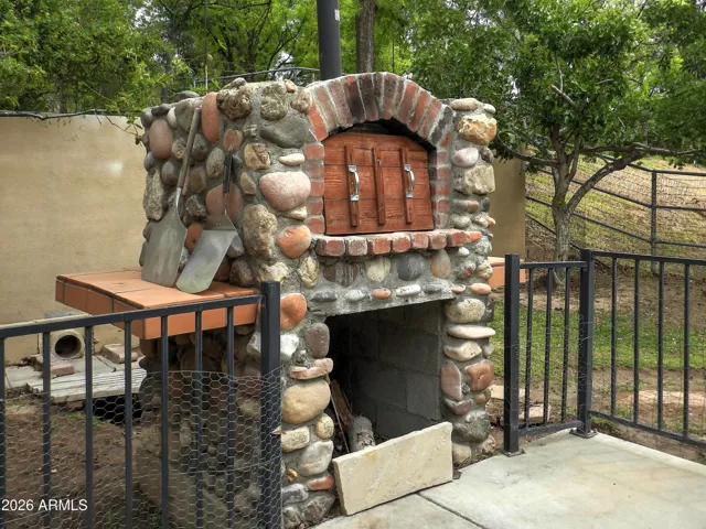 Wood burning stone pizza oven on back patio