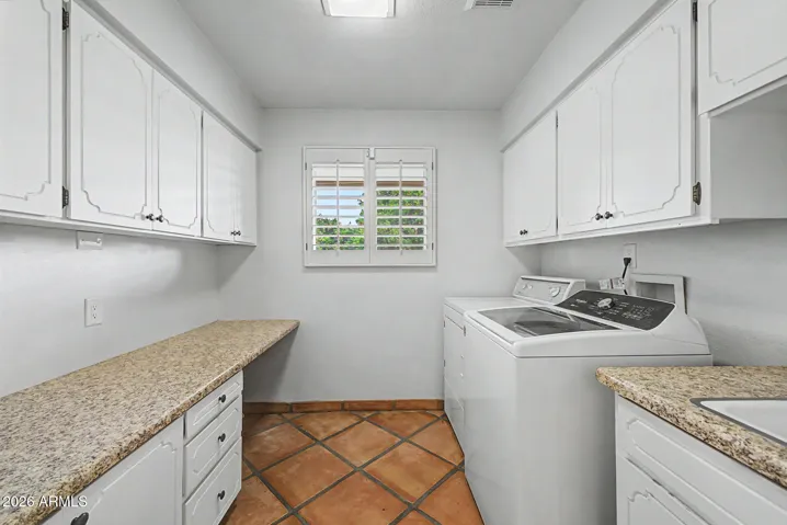 Main floor laundry - utility sink, folding table and cabs.