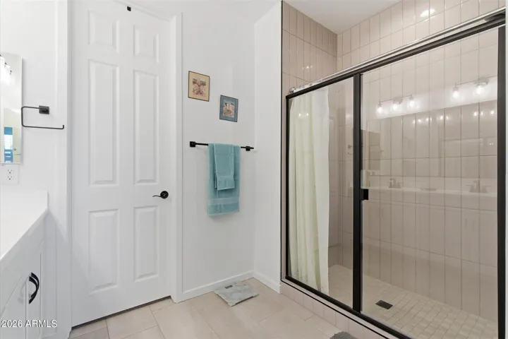 Walk-in shower with clean, modern design.