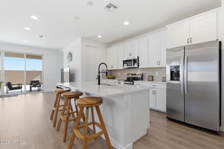 Large kitchen with center island, stainless steel appliances, and ample cabinetry