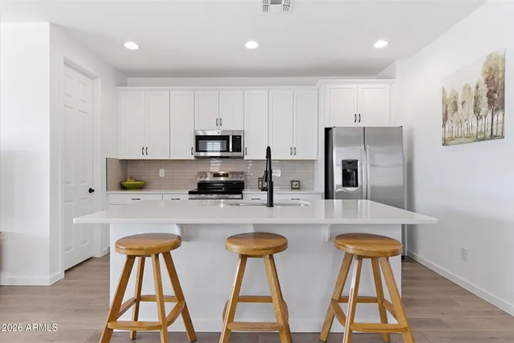 Oversized island offering additional prep space and seating.