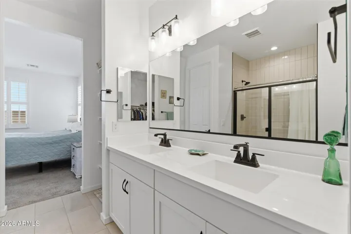 Primary bath with dual sinks and ample counter space.