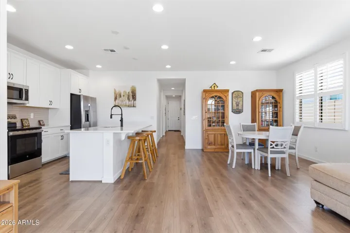 Wide view capturing the open kitchen and dining area, highlighting the spacious layout and seamless flow into the great room.