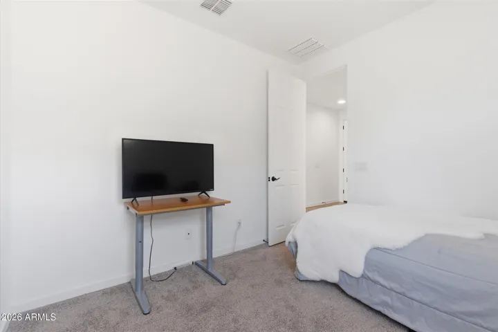 Comfortable secondary bedroom ideal for visitors or office.