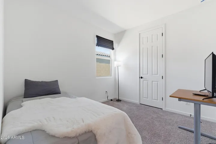 Guest bedroom with natural light and flexible use.