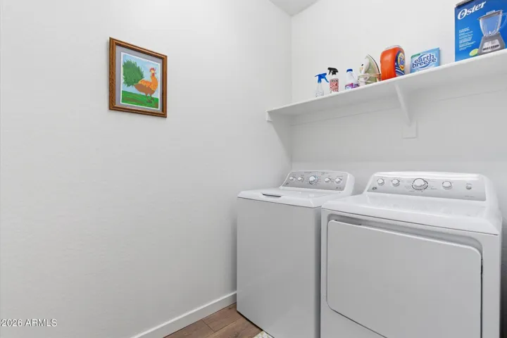Dedicated laundry room with storage space and functionality.