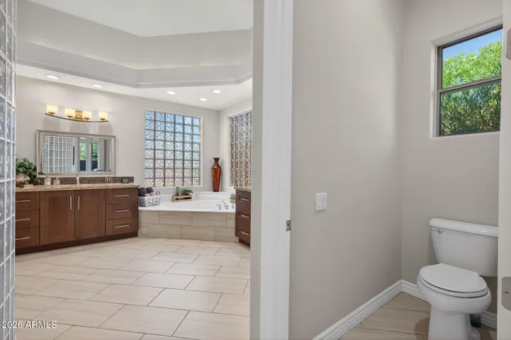 Just past the owner's closets is the private toilet room.