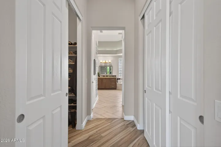 The short hallway into the owner's bath offers large walk-in closets on each side.