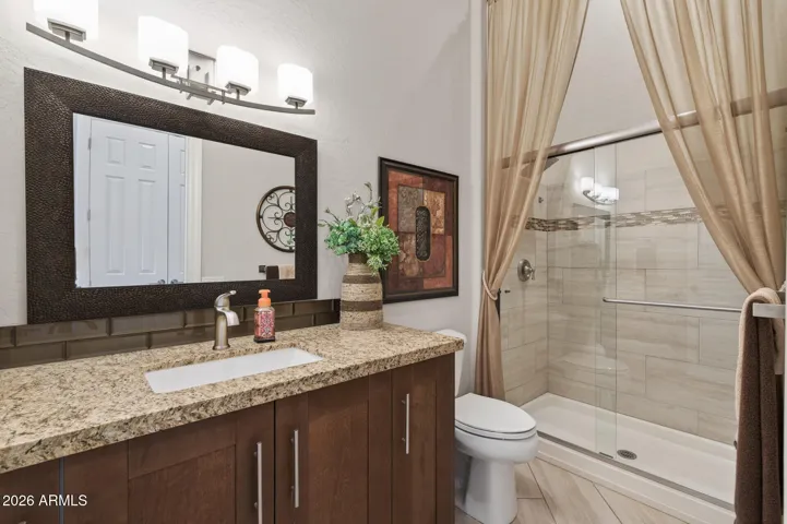Notice the updated bath with tile shower, raised vanity, granite counter, new mirror, & updated lighting.