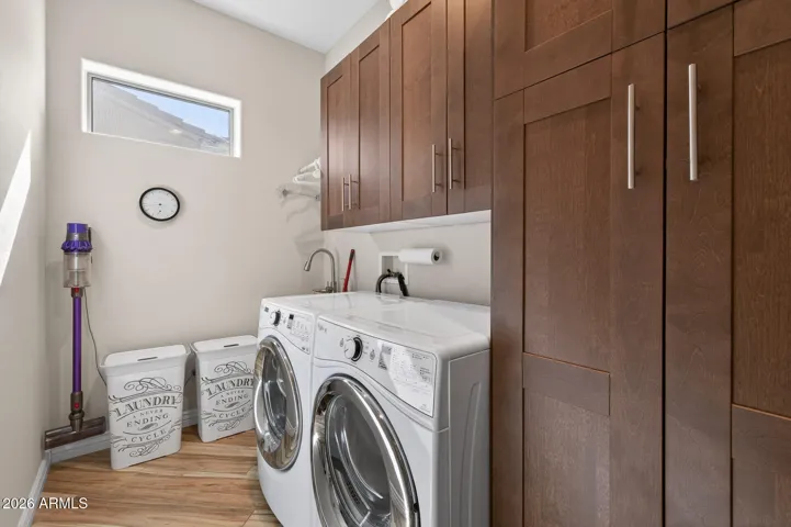 These cabinets in the laundry room are perfect for storing entertainment pieces and bulk items.