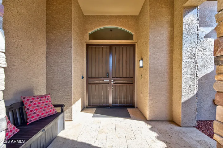 Notice the travertine front porch and double door entry w/security screen doors.