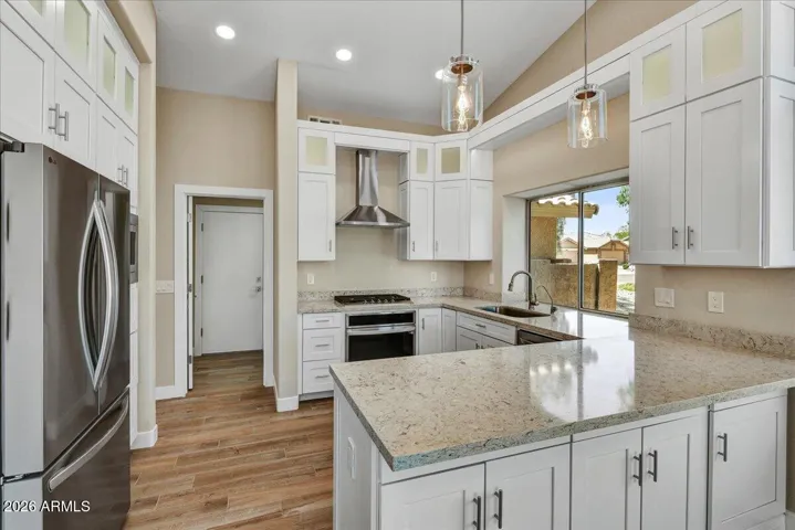Wow! No detail has been missed. Granite counters, white high-end cabinets, recessed lighting & stainless steel appliances.