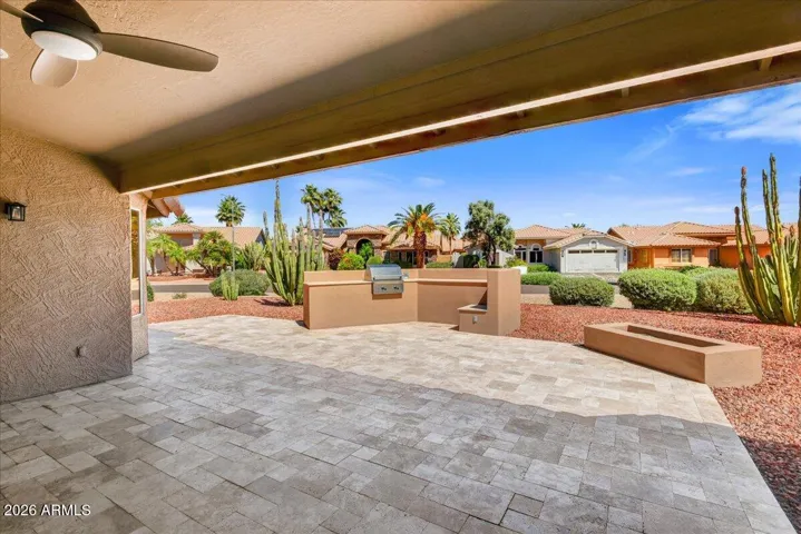 Extended travertine to built in bbq and firepit