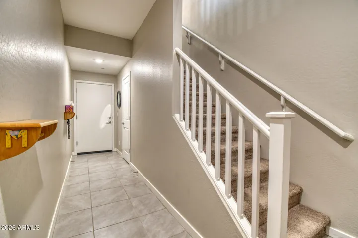 Downstairs hallway to garage, plus large storage area under the stairs.