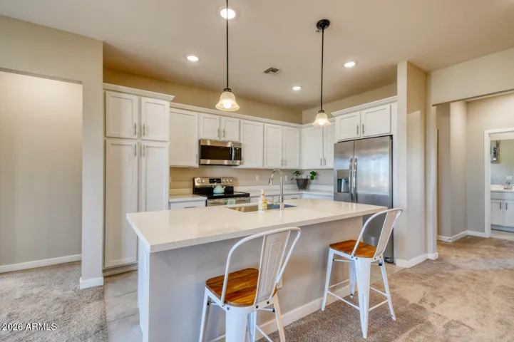 Spacious, gourmet kitchen with quartz countertops.