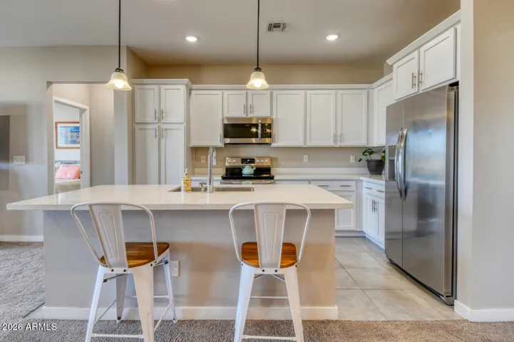 Spacious, gourmet kitchen with quartz countertops.