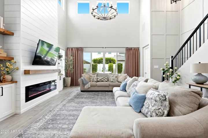 CUSTOM PANELED WALLS AND FLOOR TO CEILING ELECTRIC FIREPLACE.