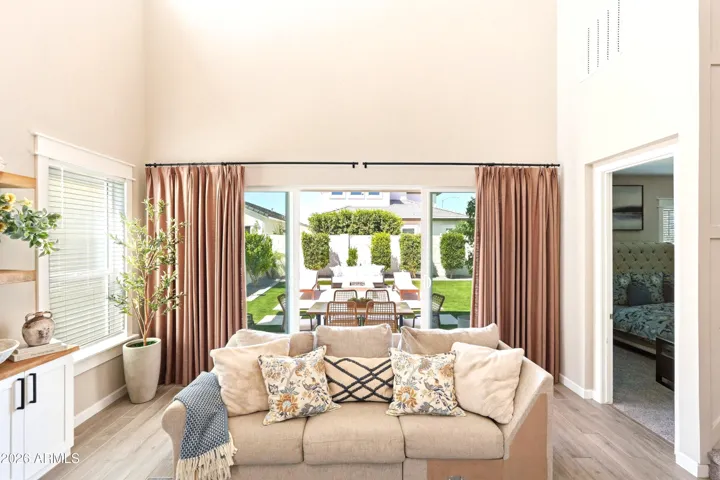 SLIDING GLASS DOORS LEAD TO AN EXTENSION OF THE BEAUTIFUL HOME'S LIVING SPACE!