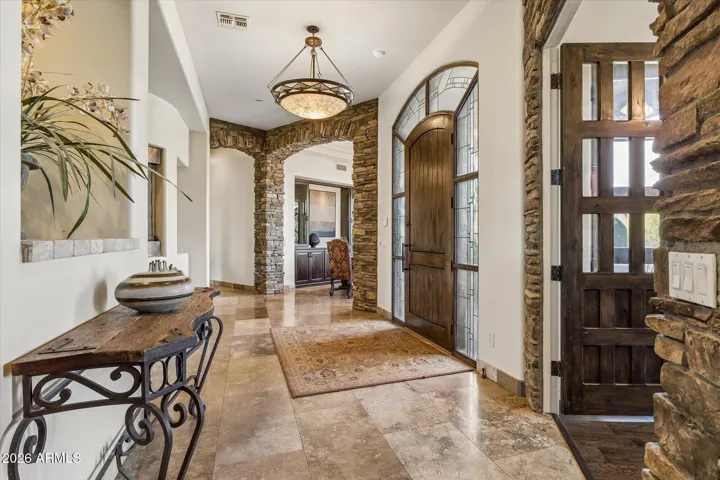 Formal dining and poker room (office) flank the entry