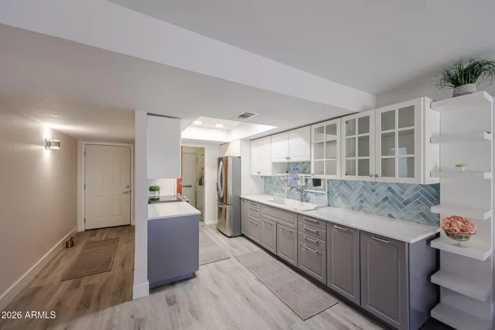 ** Beautifully spacious kitchen featuring crisp white cabinetry, Aqua-blue-green tile backsplash **