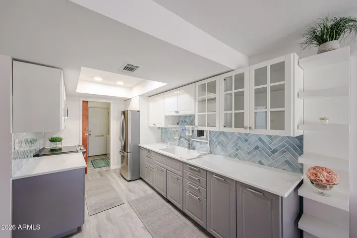 ** Beautifully spacious kitchen featuring crisp white cabinetry, Aqua-blue-green tile backsplash **