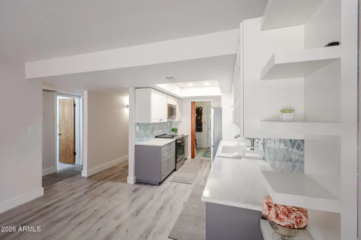 ** Beautifully spacious kitchen featuring crisp white cabinetry, Aqua-blue-green tile backsplash **