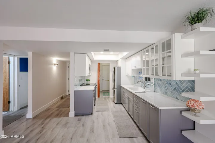 ** Beautifully spacious kitchen featuring crisp white cabinetry, Aqua-blue-green tile backsplash **