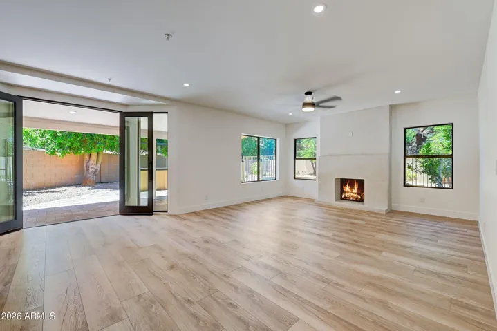 Family Room with Fireplace and Custom Doors that Open to Covered Patio
