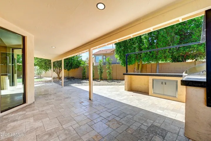 Covered Patio Area with Travertine Decking and BBQ Peninsula