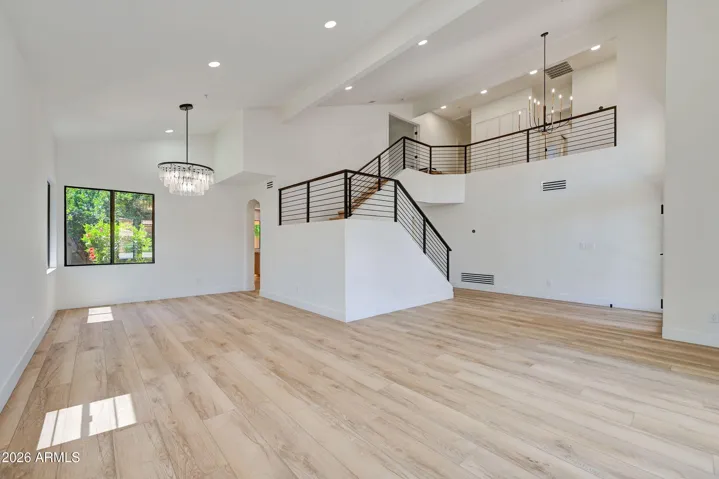Formal Living and Dining Areas with Vaulted Ceilings and Custom Staircase