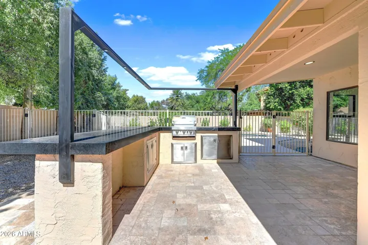 Large Outdoor Patio with Built-in BBQ and Custom "Peninsula Style" Hard Surface Bar, Plus Overhead Lighting and Travertine Decking