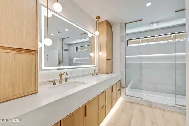 Master Bedroom with Custom Dual Headed Shower with Light Feature and Smart Mirror at Vanity