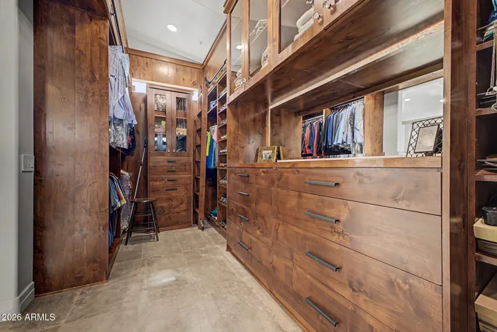 Huge primary closet with extensive custom storage
