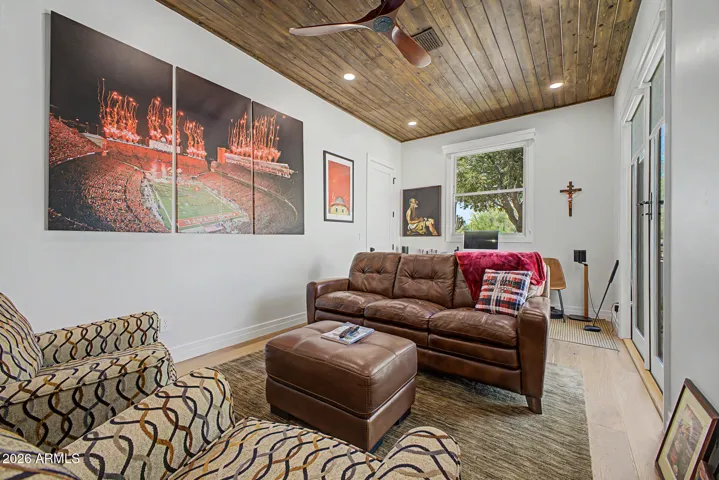 The roomy den with beautiful tongue and groove ceiling is currently configured as a recreation/game room