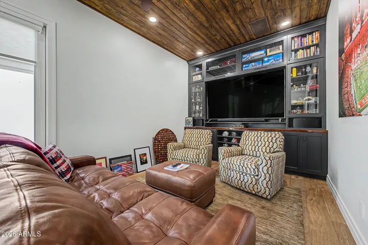 The roomy den with beautiful tongue and groove ceiling is currently configured as a recreation/game room