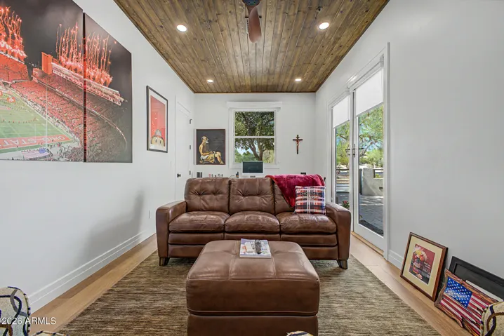 The roomy den with beautiful tongue and groove ceiling is currently configured as a recreation/game room