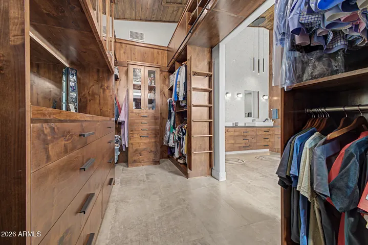 Huge primary closet with extensive custom storage
