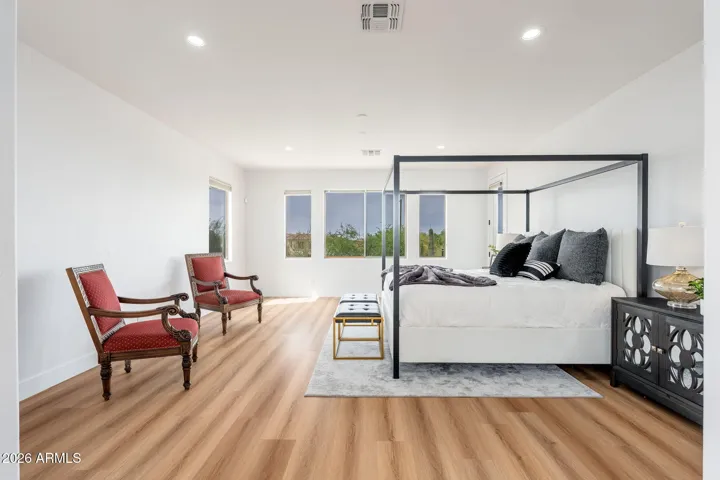 Primary bedroom with sitting room and door to balcony