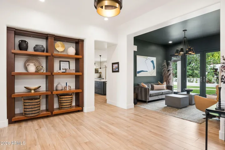 The custom shelving adds a designer touch, while the seamless flow into the living area creates the perfect setup for everyday living and entertaining.