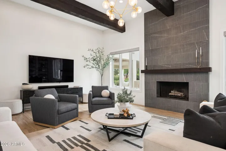 The cement tile fireplace and wood beams are a perfect mix of modern and timeless architecture