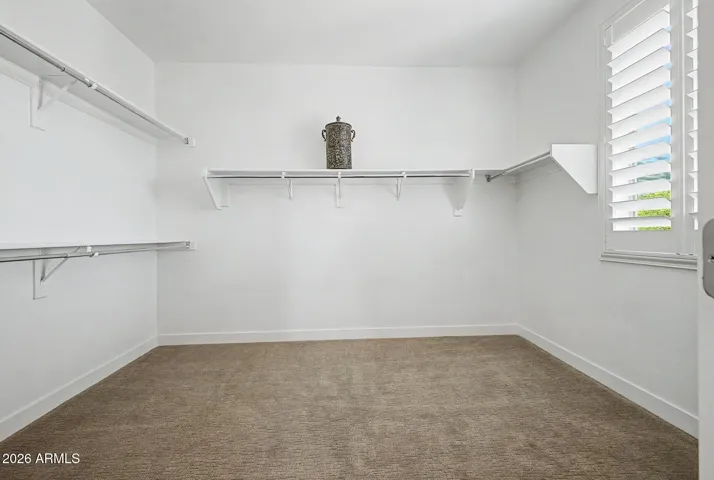 Massive primary walk-in closet with window for natural daylight just adds to the grandness of this home.
