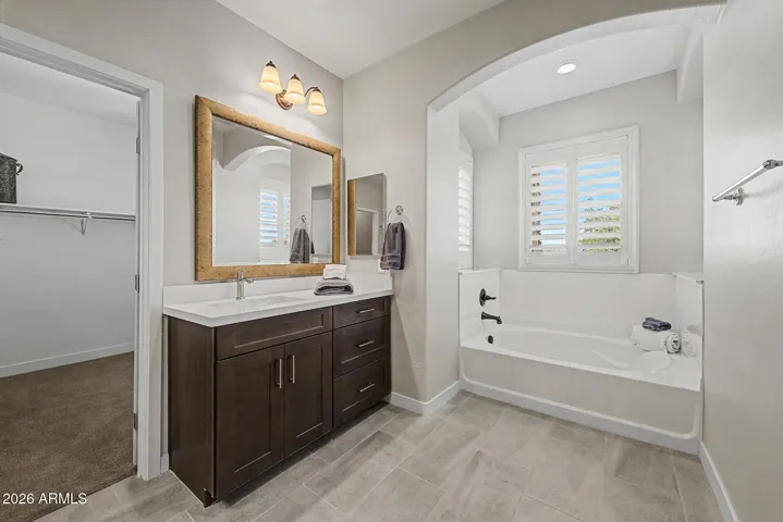 Primary ensuite has separate sinks with lots of counter space and the garden tub is surrounded on 3 sides with active windows and shutters.