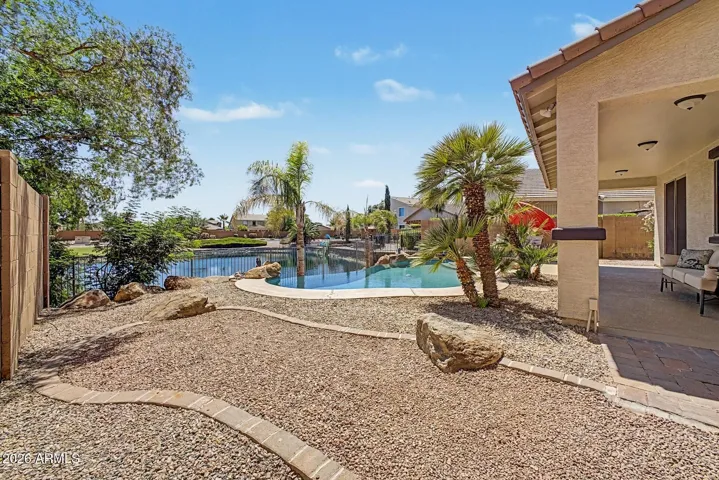 Serene views of the water in your pool and the lake behind.