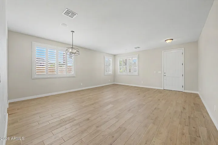 Formal living and dining room with large windows and privacy shutters greet you as you enter this beautifully updated home.