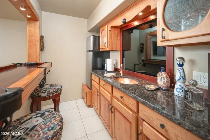Wet bar featuring mini pool table - copper sink - mini fridge