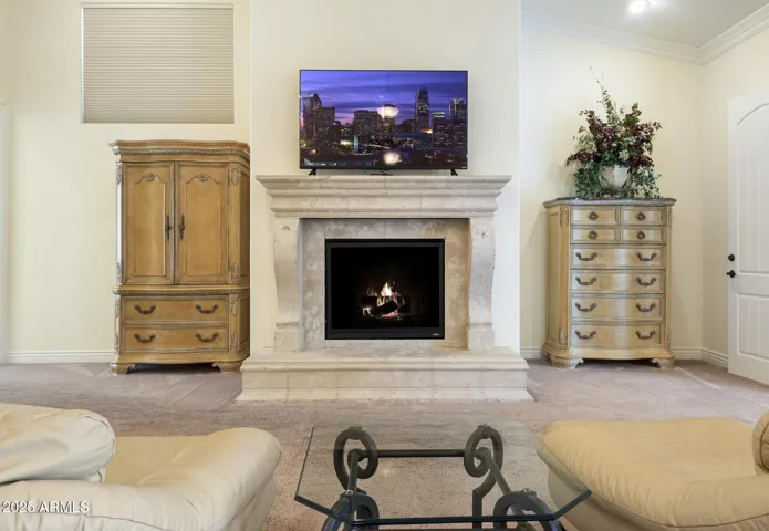Upper level primary ensuite bedroom with gas fireplace
